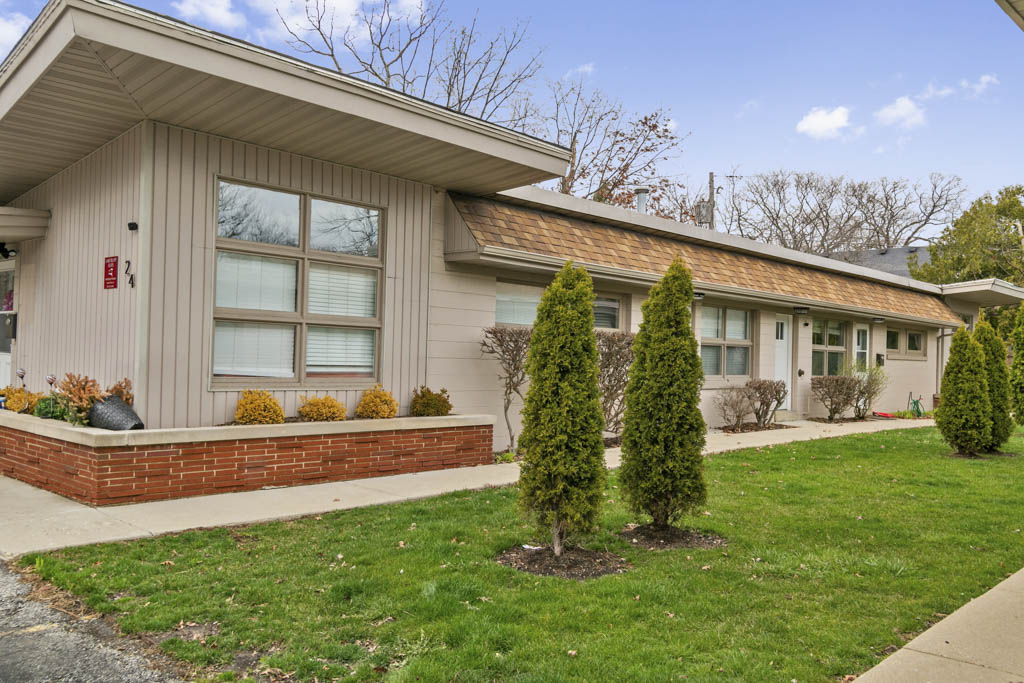 A gym with several fully contoured exercise machines, accompanied by weights, standing inside a room with beige walls and ...