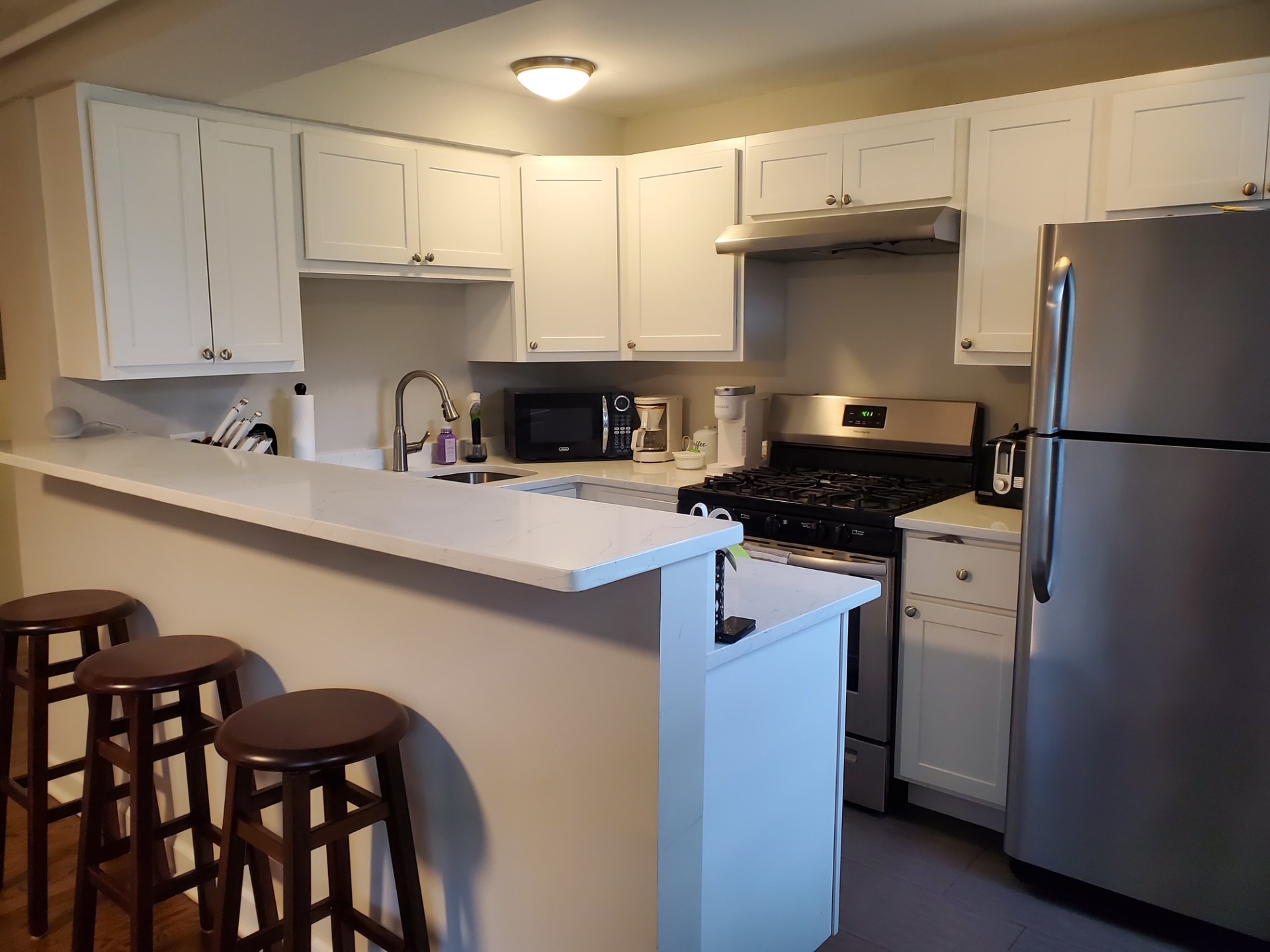 A gym with several fully contoured exercise machines, accompanied by weights, standing inside a room with beige walls and ...